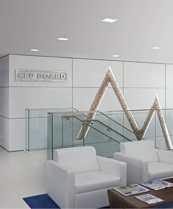 Law firm reception desk against a burnished Venetian plaster wall carrying the Orrick mark