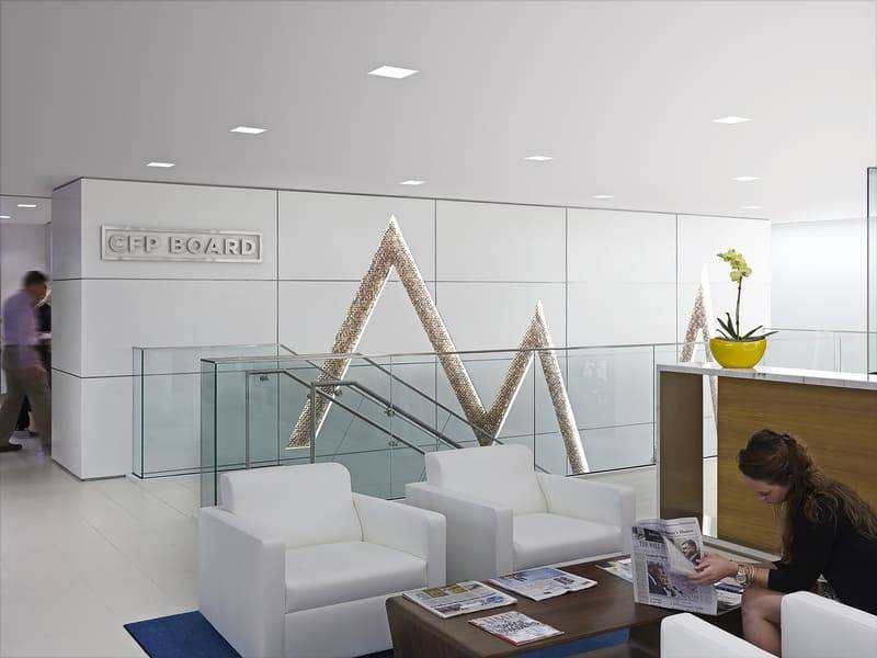 Office reception with a sculptural plaster feature wall