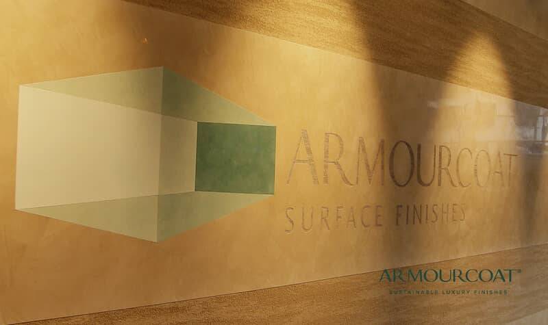 Polished Armourcoat plaster wall with the brand's surface-finishes signage