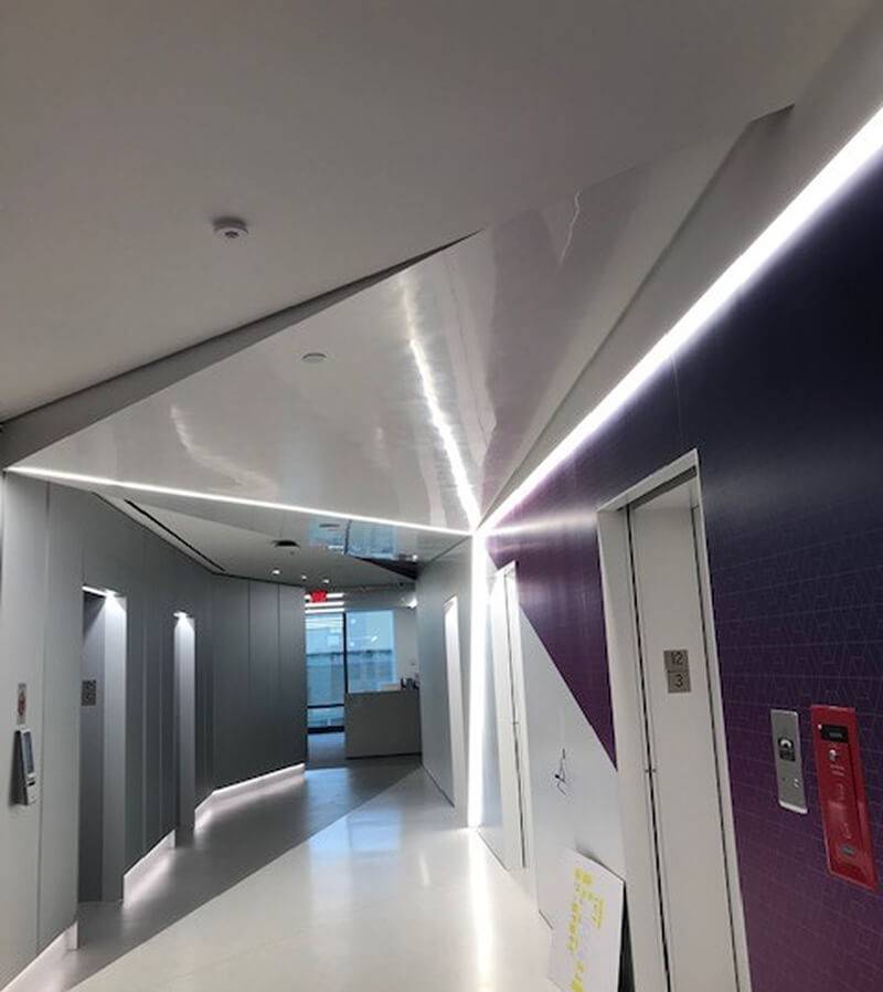 Completed Senza installation: lift lobby with acoustic plaster ceiling and decorative walls