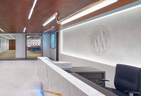 FEC lobby in Washington DC with a stencilled plaster emblem wall