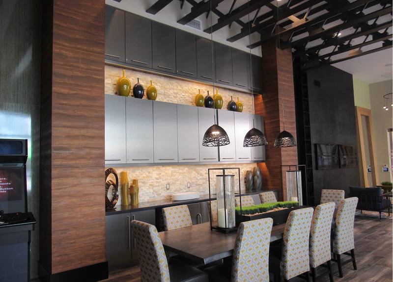 672 Flats, its columns in hand-tooled woodgrain plaster against a smooth plaster wall
