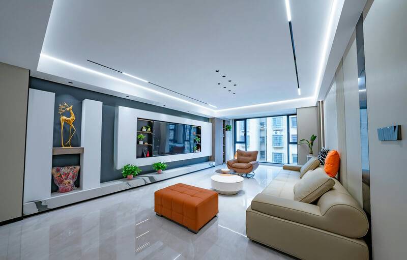 Living room with a plaster feature wall, recessed lighting and a city view
