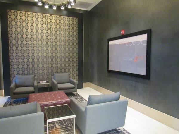 Media room at Pike 3400 Apartments with a burnished Armurella plaster wall