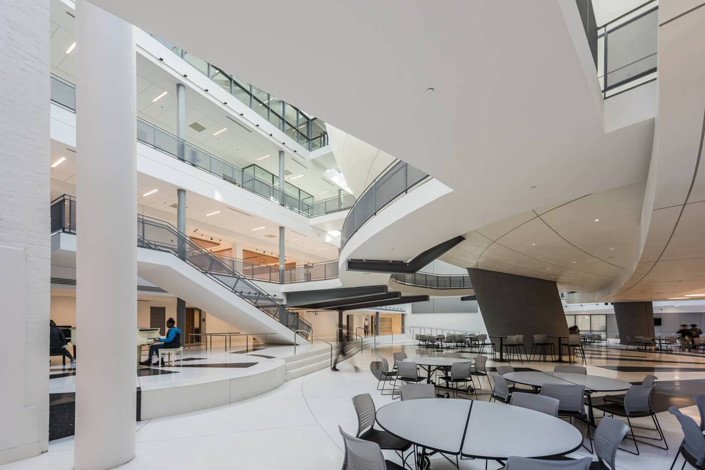 Atrium with hand-troweled plaster surfaces catching daylight